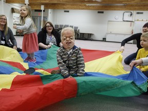Porter Stanley takes part in the parachute game at preschool in Onoway, Alta., on Wednesday, November 7, 2018. Porter Stanley is one of 30 people in the world to be diagnosed with Beare-Stevenson syndrome, a craniofacial disorder.