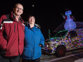 Brad Sawyer and Vivian Sawyer stand in front of their Christmas themed van, nicknamed Cilantro, in front of their home in Regina's north end.