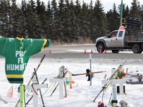 Work crews wait for paint on the highway to dry on Dec. 13, 2018, at the intersection of Highways 35 and 335. Painting stop lines on Secondary Highway 335 was one of the recommendations given in a recently released report on ways to improve the intersection where the Humboldt Broncos bus collided with a semi-trailer truck on April 6, 2018, killing 16 and injuring 13. (Susan McNeil photo for Saskatoon StarPhoenix)