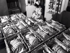In this 1930, file photo, a nurse holds a baby in the nursery of the Pennsylvania Hospital in Philadelphia.