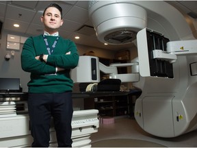 Dr. Joshua Giambattista stands next to a linear accelerator machine, used for radiation therapy, at the Pasqua Hospital on Dewdney Avenue.