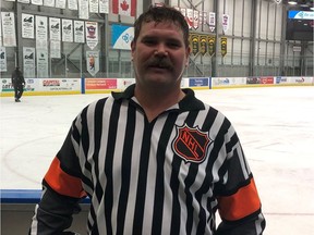 Luke McGeough, wearing a jersey that belonged to his late father Mick, leaves the ice after officiating a Saskatchewan Midget AAA Hockey League game on Wednesday in Regina.
