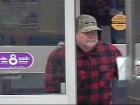 A suspect is shown in a screengrab from video in a handout from the Medicine Hat Police Service Facebook page. Saskatoon police have charged a former Winnipeg television news director in a bank robbery that occurred in July.Stephen Vogelsang, who is 53, is charged with robbing two banks in that city.