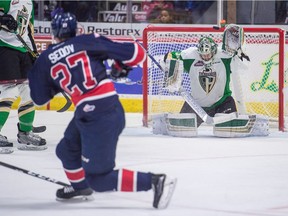 The Regina Pats' Nikita Sedov (27) fires the puck just high of the net guarded by the Prince Albert Raiders' Ian Scott (33) during a WHL game at the Brandt Centre on Saturday.