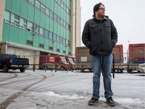 Angus Livingstone, a Canada Post employee, stands in front of the Canada Post building on Saskatchewan Drive. Livingstone was present when a truck being loaded with parcels was stolen from the loading bay visible behind him.