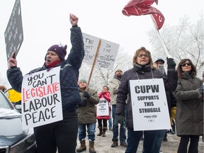 People rally in front of Liberal MP Ralph Goodale's office on University Park Drive against use of back-to-work legislation by the federal government against Canadian postal workers.