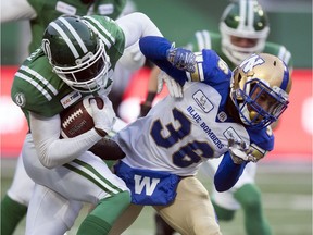 Loucheiz Purifoy, left, is shown returning a kickoff for the Saskatchewan Roughriders during the 2018 West Division semi-final against the visiting Winnipeg Blue Bombers.