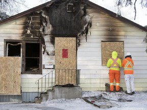 City of Regina Crews board up a house on the 700 block Cameron after an early morning house fire in Regina.