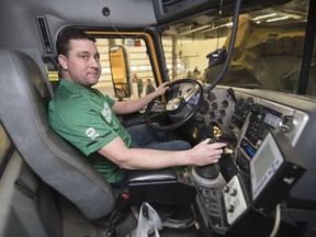 Devin Bell, operator and supervisor of operations, sits in the drivers seat of a snow plow at the Ministry of Highways and Infrastructure facility in Regina.