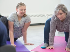 Laura Elsaesser, right, Ainsley Elsaesser participate in a yoga class being held at the new Joshua Tree Learning Centre on Albert Street.