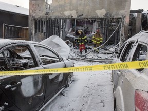 BEST PHOTO ** REGINA, SASK : January 21, 2019  -- Fire personnel   investigate what amounts to not much more than the skeleton of a home sits burned out on Plains Road in Pilot Butte. Two burned out vehicles sit on the driveway. BRANDON HARDER/ Regina Leader-Post