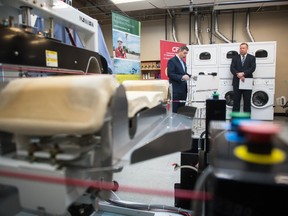 Saskatchewan trade, export and development minister Jeremy Harrison, left, speaks about reducing government red tape at an event held at Busy Bee Cleaners on East Quance Street. To his right is parks culture and sport minister Gene Makowsky.