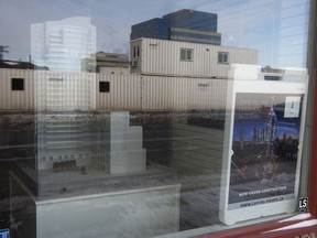 A sign stating construction is underway for the Capital Pointe project sits in the window of the sales office in Regina on Friday.