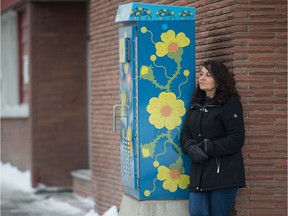 Phyllis Jarrett stands next to a traffic control box, which wears her artwork, on Albert Street. The work is part of the Regina Downtown Business Improvement District Mural Art Program.