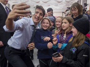 Prime Minister Justin Trudeau takes a photo with a group of young people as he attends Fundy Royal MP Alaina Lockhart‚Äôs nomination event in Quispamsis, N.B., on Wednesday, Jan. 23, 2019.
