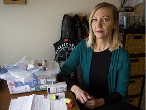 Tara Gorecki, whose home is saturated by neighbours' second-hand smoke, is pictured with her son's asthma medication and the letters she has sent to city officials and the Saskatoon Housing Authority. (Saskatoon StarPhoenix/Matt Smith)