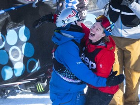 Regina's Mark McMorris, left, celebrates with Rene Rinnekangas of Finland after scoring 96 points on his final run to beat Rinnekangas' 94 and win the gold in the men's snowboard slopestyle final Saturday at the Winter X Games in Aspen, Colo.