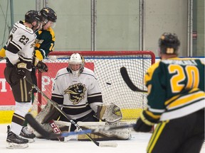 University of Manitoba Bisons netminder Byron Spriggs surrenders a goal by the University of Regina Cougars' Zak Hicks during Canada West men's hockey action Saturday at the Co-operators Centre. The Cougars won 6-3.
