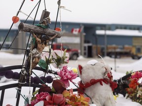 A memorial is shown in front of the school where a teen went on a shooting spree in 2016, in La Loche, Sask. Friday, Feb.23, 2018. The mayor of a northern Saskatchewan community where a fatal school shooting took place three years ago says there's mixed feelings ahead of the high school's grand re-opening. Four people died and another seven were injured when a young man shot up a school and home in La Loche in January 2016.