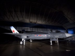 A F-35 Joint Strike Fighter is seen in a hangar in Ottawa on July 16, 2010. A senior official at the Department of National Defence says there are no plans to quit as a member of the F-35 stealth fighter program until the government knows which jet it plans to buy to replace Canada's aging CF-18s. That means Canada will continue to pay tens of millions of dollars over the next couple of years to help pay for development of the fighter jet -- even though it may end up buying something else. DND's head of procurement, Patrick Finn, says staying on as one of nine partner countries makes sense so Canada can compete for billions of dollars in contracts associated with the F-35.