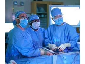 Dr. Gavin Beck, surgical assistant, and Dr. Yigang Luo (left to right) during kidney transplant surgery at St. Paul's Hospital.