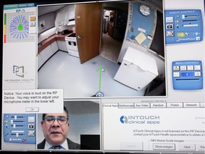 Dr. Ivar Mendez demonstrates remote presence technology in Regina on May 12, 2014.