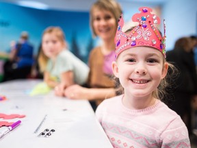 Zephyrine Vandenberg sits at the crafts table wearing a crown she designed during the New Year's Day Levee held at Government House.