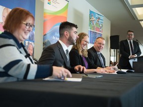 From left, Sask Sport chair Leslie Blyth, SaskCulture president James Rose and president of Saskatchewan Parks and Recreation Association Coralie Bueckert join Saskatchewan parks culture and sport minister Gene Makowsky to sign a lottery funding agreement at a media event held at the Mackenzie Art Gallery.
