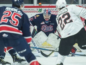 Regina Pats goaltender Dean McNabb braces for a shot by Moose Jaw Warriors' Kaeden Taphorn (22) during a WHL game at the Brandt Centre on Dec. 14.