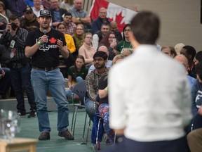 Court Klein asks a question while Prime Minister Justin Trudeau speaks at a town hall at the University of Regina.