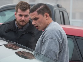 Duran Redwood, right, leaves Regina's Court of Queen's Bench, under the supervision of law enforcement officers. Redwood is charged with second-degree murder in the death of his partner Celeste Yawney.