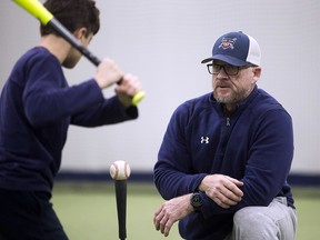 Gregg Zaun instructs Matthew Donia, 10, at the Gregg Zaun's Hitting Camp in Kleinburg, Ont. on Thursday, January 17, 2019. (Stan Behal/Toronto Sun)