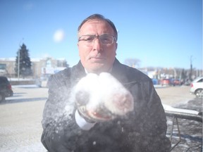 Dr. Simon Kapaj, a medical health officer with the Saskatchewan Health Authority (SHA), blows snow at a StarPhoenix camera outside of the SHA's public health building on Idylwyld Drive in Saskatoon on Feb. 13, 2019. Kapaj said it's important for people to take the proper precautions during cold weather as it can cause permanent damage to the body.