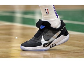 In this Feb. 7, 2019, photo, Los Angeles Lakers forward Kyle Kuzma walks on the court during an NBA basketball game against the Boston Celtics in Boston. He is wearing Nike's latest performance basketball shoes, which from concept to reality, took about three years to put together. Or 30 years, depending on how you count. The Nike Adapt BB _ a self-lacing smart shoe that can be controlled by a smartphone _ gets released to the public on Sunday, Feb. 17, 2019, a date that just happens to coincide with the NBA All-Star Game in Charlotte. It has a motor embedded within the shoe, and a hefty $350 price tag. It has a motor embedded within the shoe, and a hefty $350 price tag.