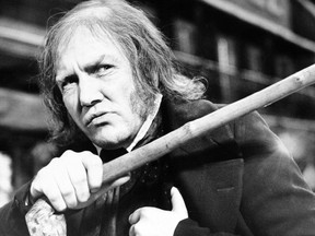 FILE - In this Jan. 15, 1970 file photo, British actor Albert Finney waves his cane while playing the title role in "Scrooge," at Shepperton Studios. British Actor Albert Finney, the Academy Award-nominated star of films from "Tom Jones" to "Skyfall" has died at the age of 82 his family said on Friday, Feb. 8, 2019.
