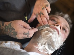 Jason Zalusky, owner of Bluecore Barber Company, gives Paul Clarke a hot towel straight razor shave in his newly opened shop in Regina. Zalusky is a 3rd generation blue collar worker with his family business J.W. Zalusky & Sons Ltd. 10 years ago the last place Zalusky thought he would be standing would be in his own barber shop. Zalusky says "After a long uphill battle of travelling the United States for barber school, it is an incredible feeling to see the vision finally all come together 5 years later."