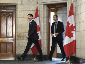 Prime Minister Justin Trudeau leaves his office with his principal secretary Gerald Butts to attend an emergency cabinet meeting on Parliament Hill in Ottawa on Tuesday, April 10, 2018.