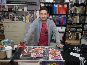 WolfCop creator Lowell Dean stands behind some of his comic books in the Comic Readers store on 11th Avenue.