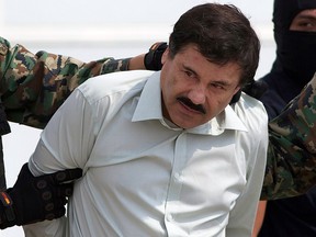 This Feb. 22, 2014 file photo shows Joaquin "El Chapo" Guzman, the head of Mexico's Sinaloa Cartel, being escorted to a helicopter in Mexico City following his capture overnight in the beach resort town of Mazatlan.