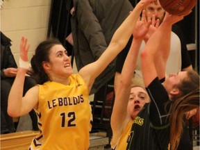 Jade Belmore of the LeBoldus Golden Suns blocks a shot in Saturday's Luther Invitational Tournament  senior girls final.