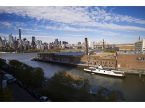 FILE- In this Nov. 7, 2018, file photo, a rusting ferryboat is docked next to an aging industrial warehouse on Long Island City's Anable Basin in the Queens borough of New York. Amazon said Thursday, Feb. 14, 2019, that it will not be building a new headquarters in New York, a stunning reversal after a yearlong search.