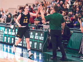 Fifth-year forward Christina McCusker gets a high-five from University of Regina Cougars women's basketball coach Dave Taylor on Saturday at the Centre for Kinesiology, Health and Sport. McCusker, playing in her final regular-season series, helped the Cougars sweep the arch-rival University of Saskatchewan Huskies.