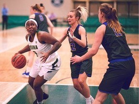 Kyanna Giles, left, had 13 points and 11 rebounds to help the University of Regina Cougars women's basketball team register a playoff win Thursday.