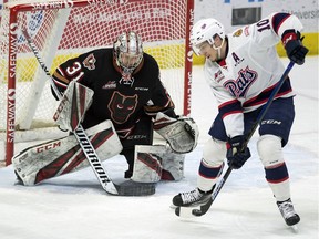 The Regina Pats' Austin Pratt tips the puck past Calgary Hitmen goalie Jack McNaughton in WHL action at the Brandt Centre on Jan. 29.