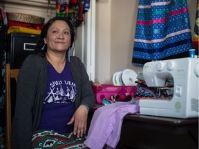 Tanya Sayer sits next to her sewing station in her Regina home. After living a life full of challenges including homelessness and incarceration, Sayer has now put herself on a better path. An artist with a sewing machine, she has been teaching members of the Regina police how to make ribbon skirts in preparation for their annual round dance.