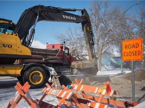 A crew works to repair a water main break on Pasqua Street near the intersection of Wood Crescent.