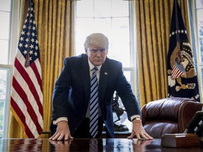 In this April 21, 2017, file photo, President Donald Trump poses for a portrait in the Oval Office in Washington after an interview with The Associated Press.