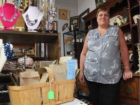 Joanne Lukash, the owner of VintageMallYXE, poses for a photo beside some of the treasures she's found on Feb. 14, 2019. She says she wants to offer antique collectors and pickers an opportunity to showcase some of their finds, without the hassle of starting their own business.