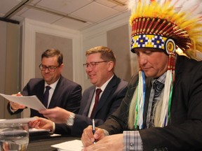 Chief of the Saskatoon Tribal Council Mark Arcand, right, alongside Saskatchewan Premier Scott Moe and Social Services Minister Paul Merriman at the Sheraton Cavalier on Friday, March 15, 2019. Arcand, alongside chiefs from the STC's member communities, were in Saskatoon to sign three agreements aimed at improving services for Indigenous children and youth in Saskatchewan.