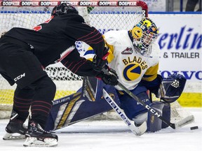 Saskatoon Blades goalie Nolan Maier stops a shot from Moose Jaw Warriors forward Eric Alarie during WHL playoff action at SaskTel Centre on Friday.